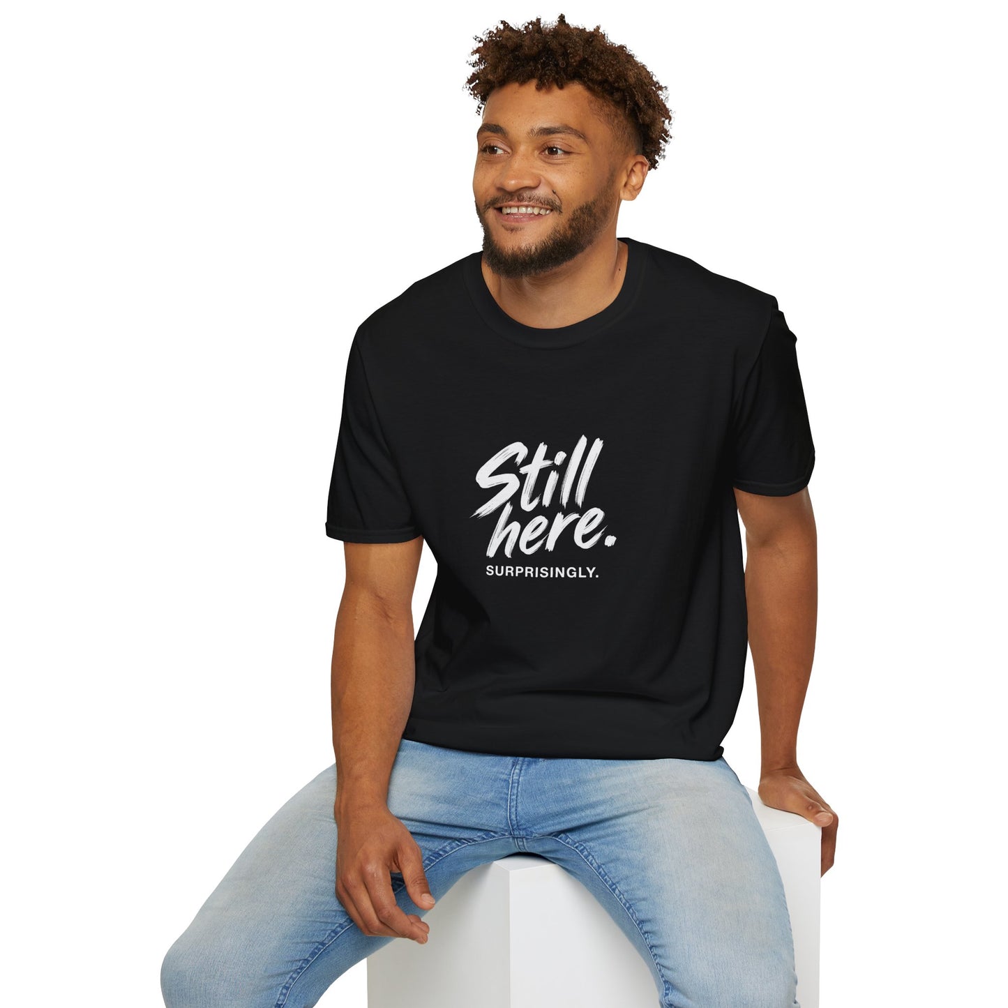 Still Here. Surprisingly. — Unisex Tee